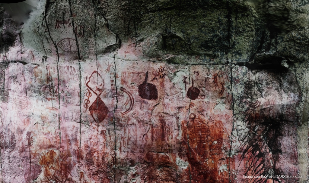 Dense rock art panel showing geometric shapes, human figures, and animals in natural light