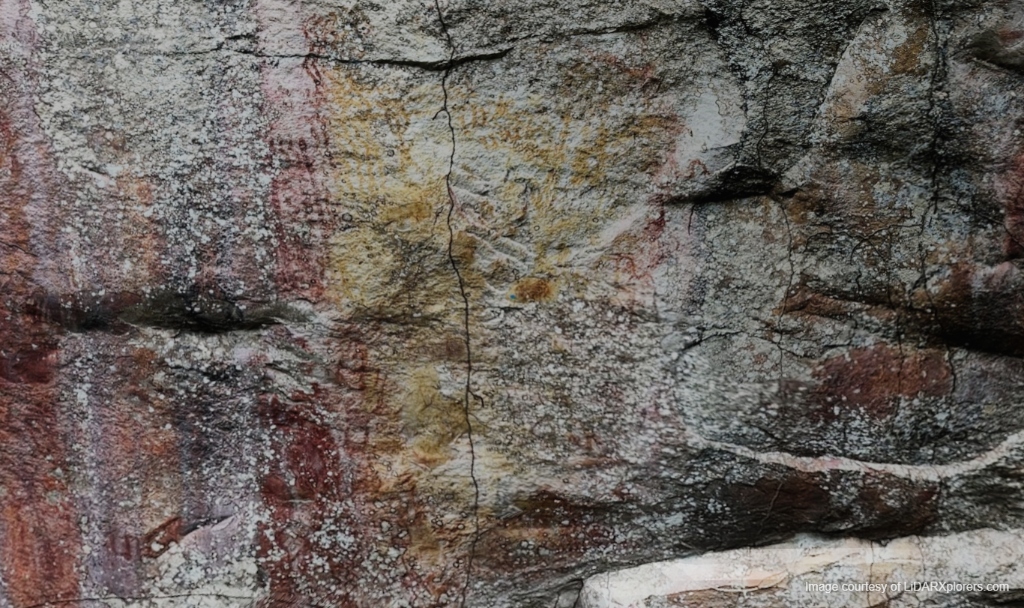 Rock panel in natural light showing both yellow and red pigments side by side
